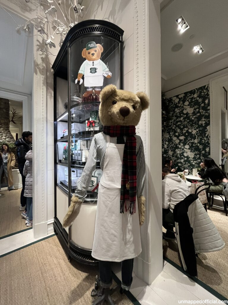 a life sized bear mannequin standing in a cafe