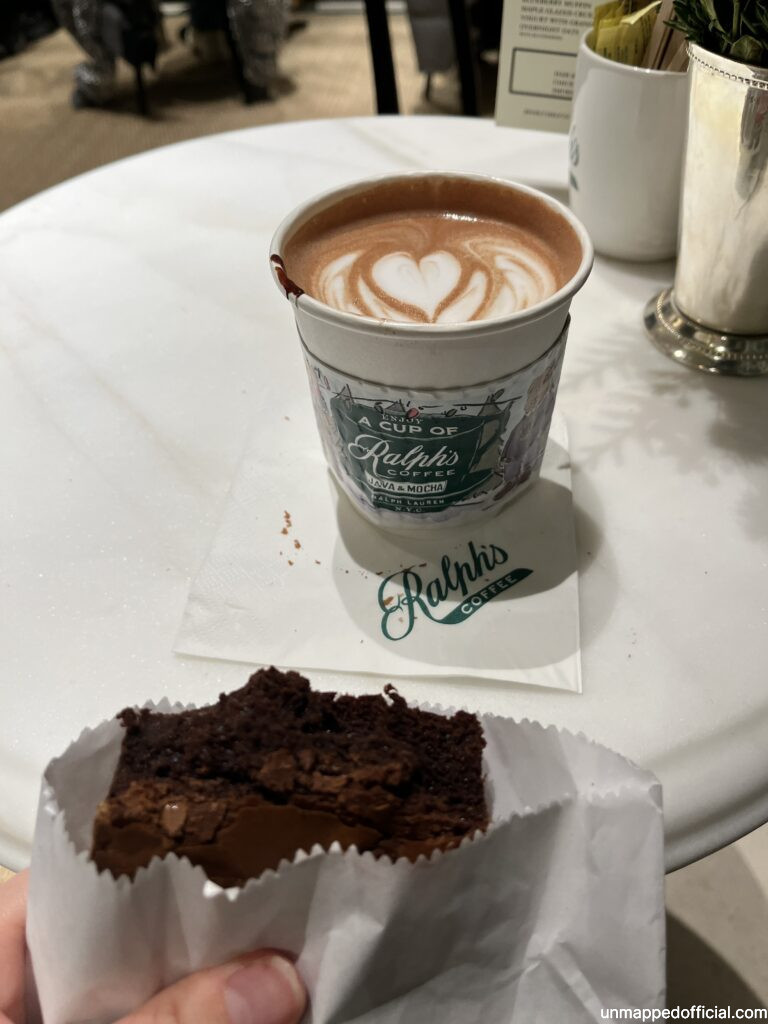 a hot chocolate and a half eaten fudge brownie