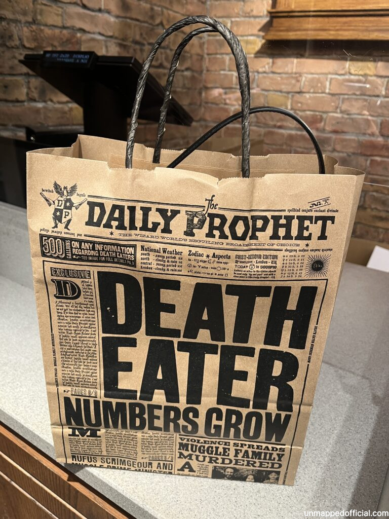 a harry potter newspaper themed paper bag.