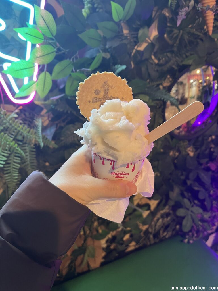 holding a small cup of lychee sorbet.