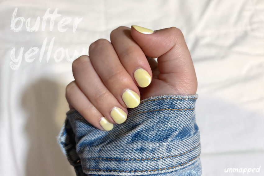 hand posing with trendy butter yellow colored nails Butter Yellow Nails for Summer 2025