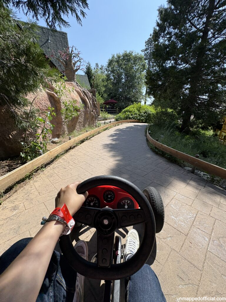 POV riders view of driving a cart/bike through a paved trail.