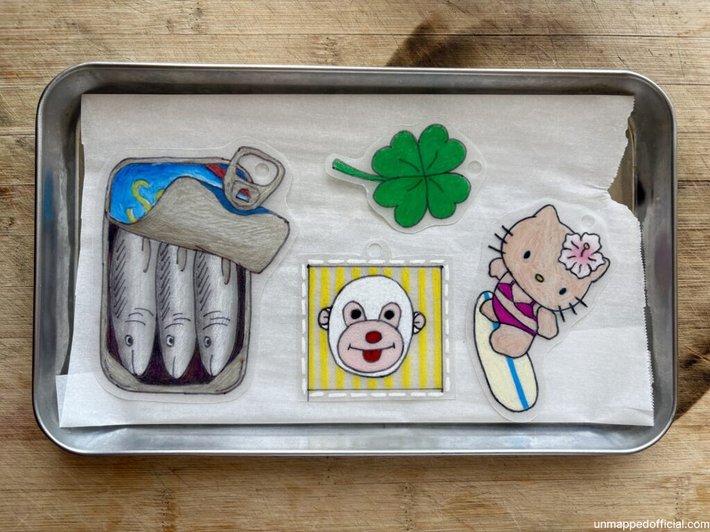 shrink plastic designs cut out and arranged on a metal tray