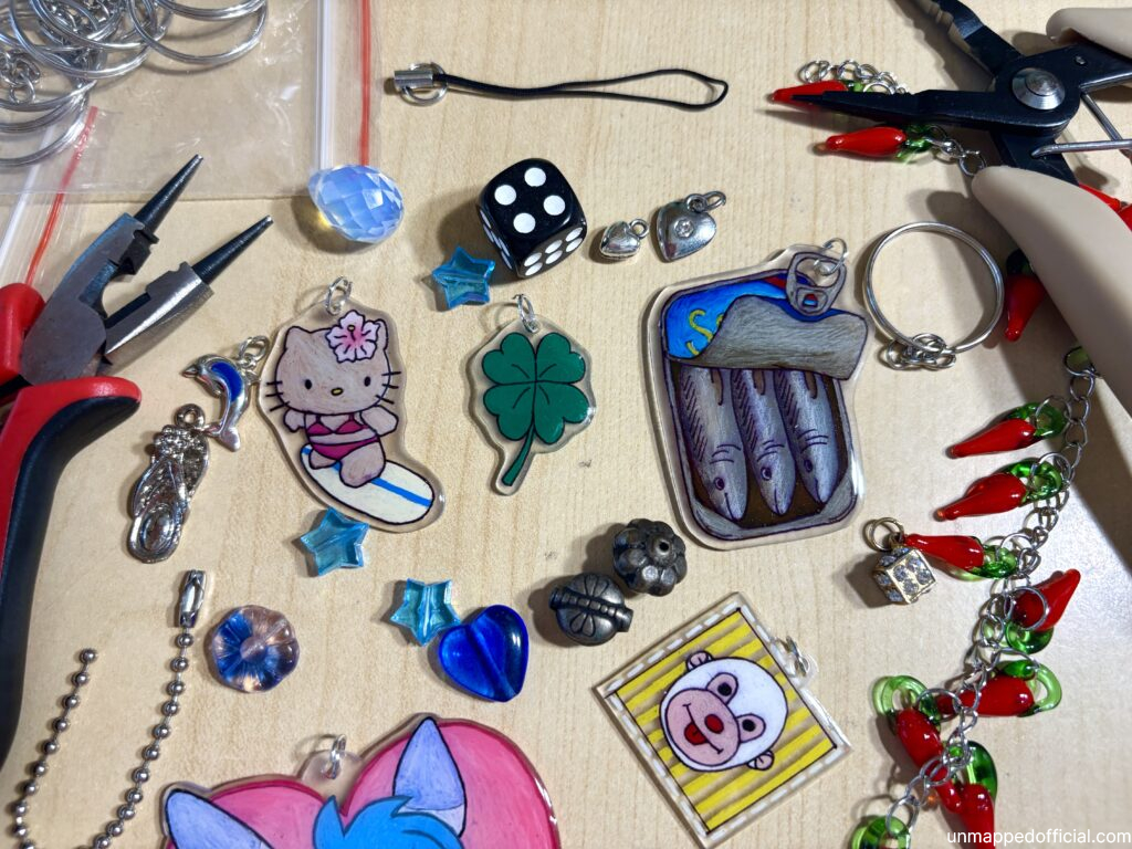 spread of charms, pliers, and beading supplies