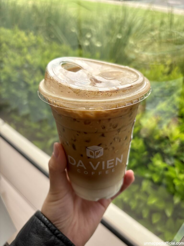 da vien coffee held up in front of a window