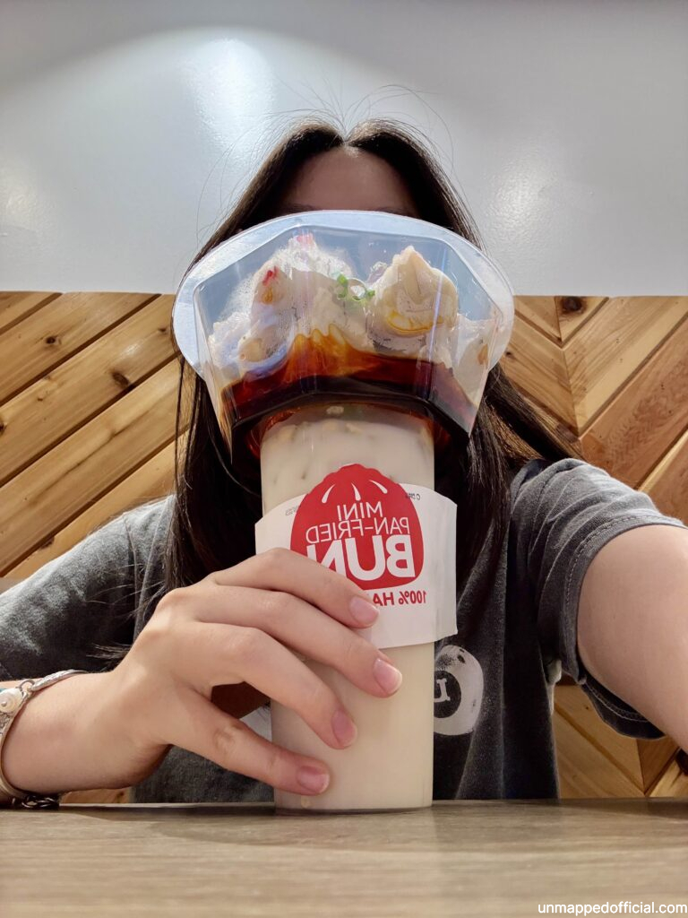 girl holding drink and bun combo