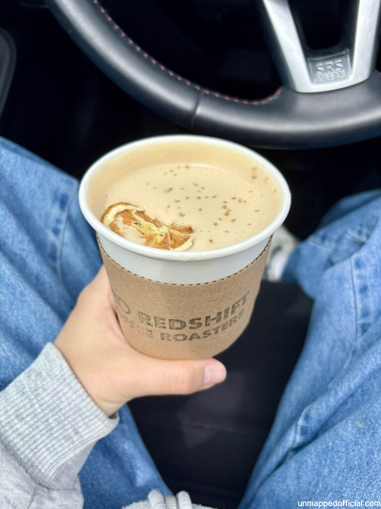 holding a coffee with a dried orange in it
