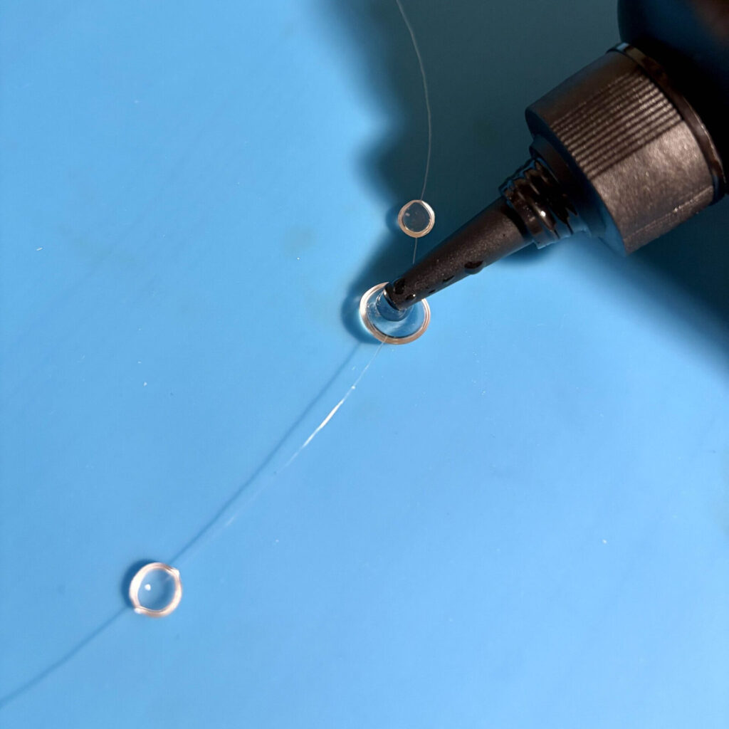 applying resin to the flat backside of the cured resin drops on the necklace