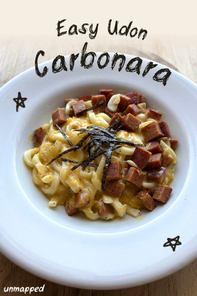 udon carbonara noodles in a white plate
