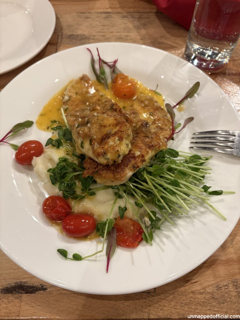 chicken francese on pea sprouts with roasted tomato and mashed potatoes